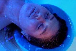 Close up of a ladies head whilst relaxing in a floatation room